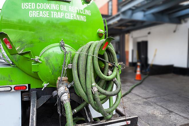 heavy-duty vacuum truck pumping out a grease trap in Dudleyville